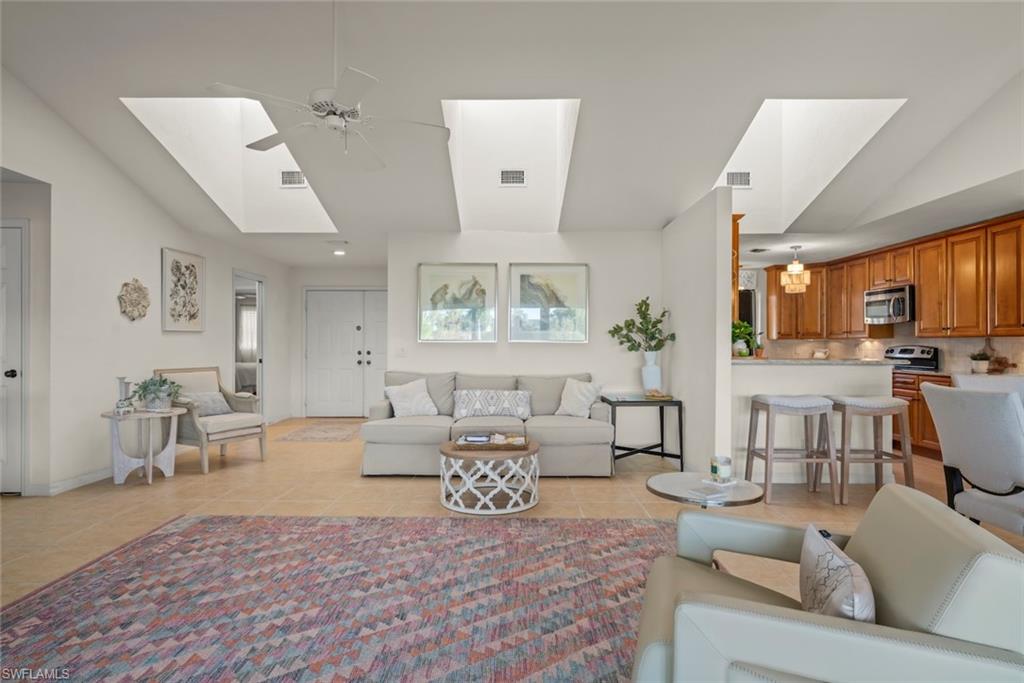 780 Waterford Drive, Unit 302 Naples, FL 34113 - Photo 16 of 47 a living room with furniture and a large window