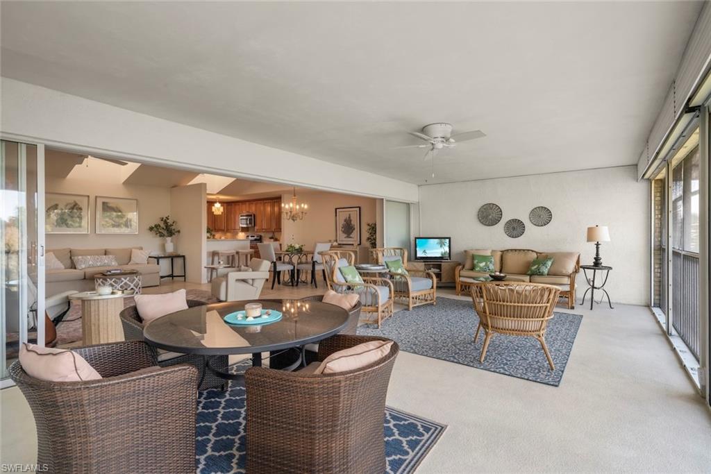 780 Waterford Drive, Unit 302 Naples, FL 34113 - Photo 18 of 47 a living room with fireplace furniture and a large window