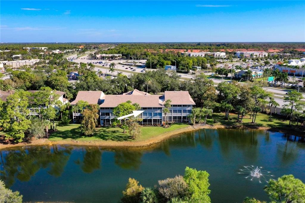 780 Waterford Drive, Unit 302 Naples, FL 34113 - Photo 23 of 47 an aerial view of residential houses with outdoor space and lake view