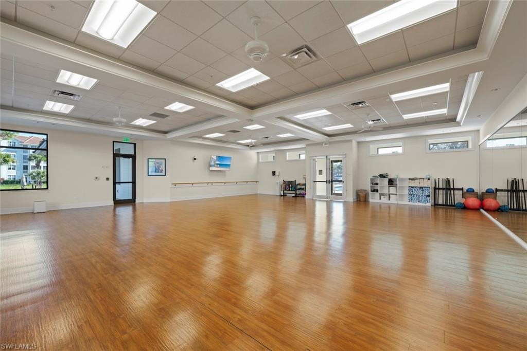 780 Waterford Drive, Unit 302 Naples, FL 34113 - Photo 40 of 47 a view of a room with wooden floor