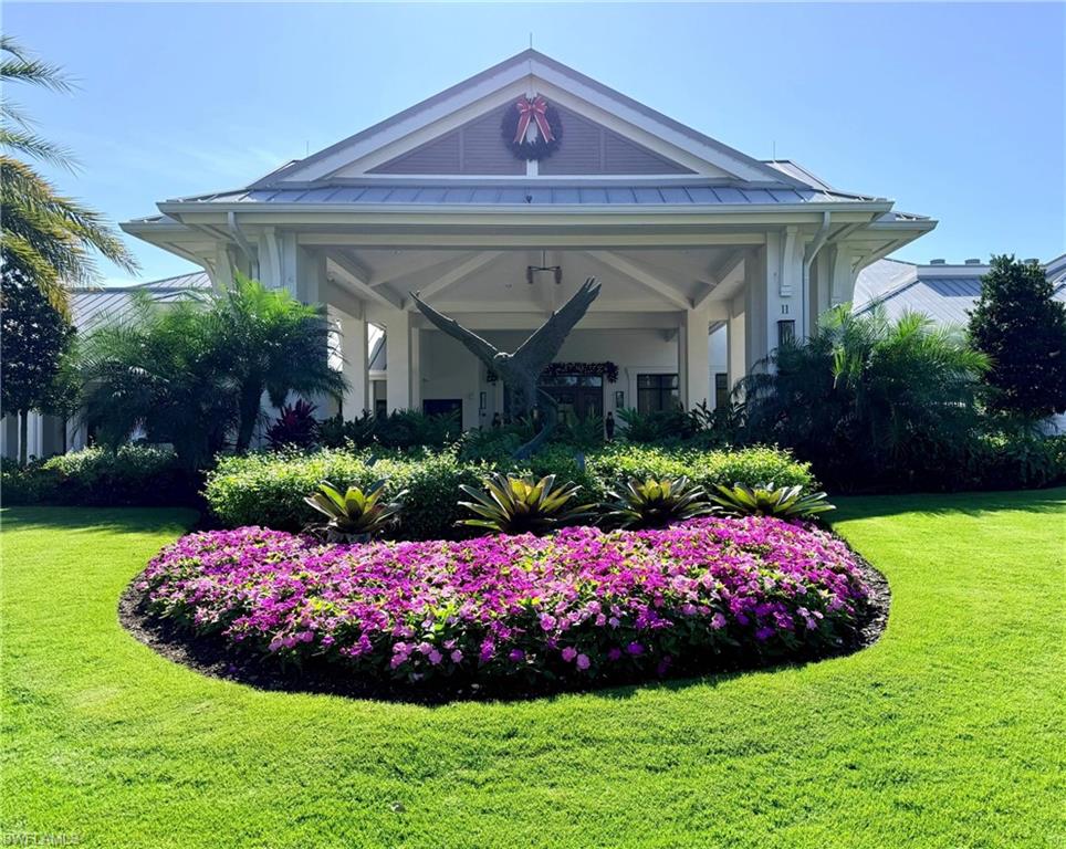 780 Waterford Drive, Unit 302 Naples, FL 34113 - Photo 46 of 47 a front view of a house with a yard