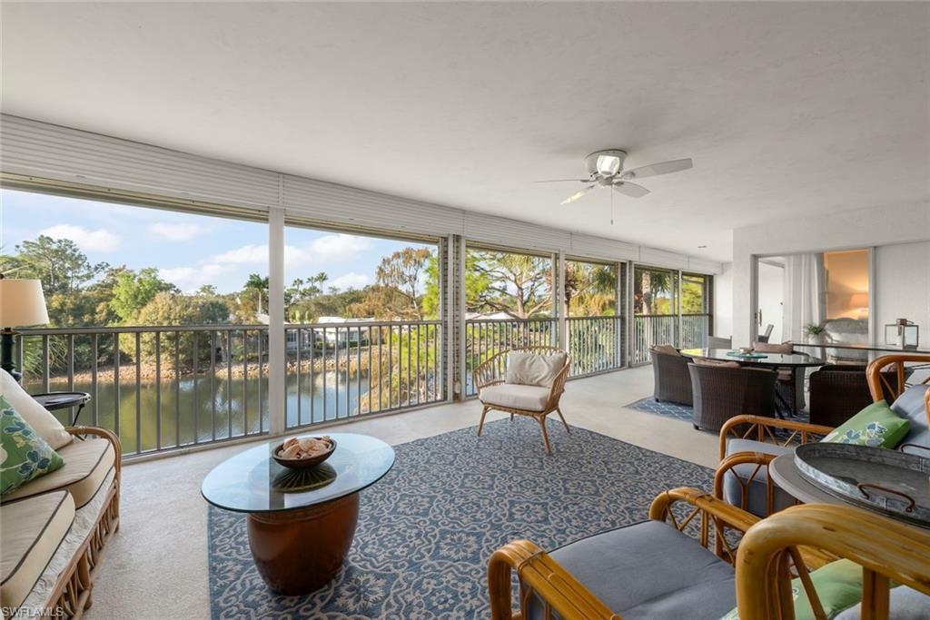 780 Waterford Drive, Unit 302 Naples, FL 34113 - Photo 8 of 47 a living room with furniture and a large window