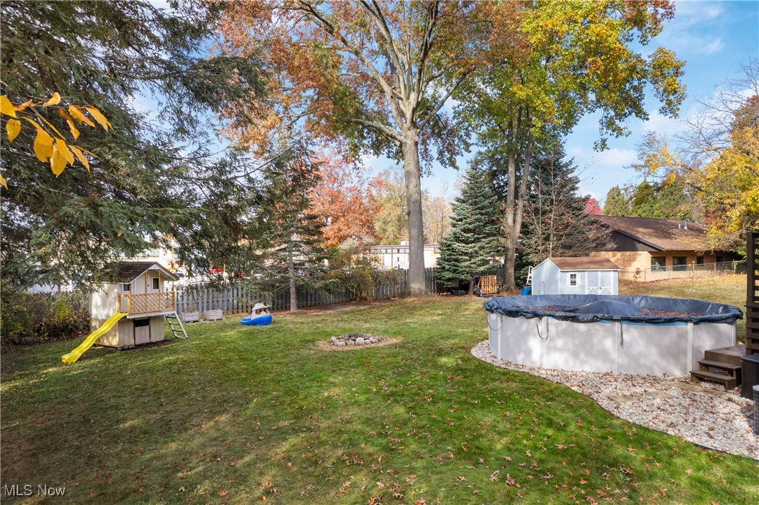 1436 Rumbaugh Circle Wooster, OH 44691 - Photo 26 of 30 View of yard with a storage unit, a playground, and a covered pool