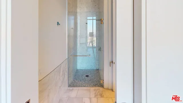 an empty room with sliding door and wooden floor