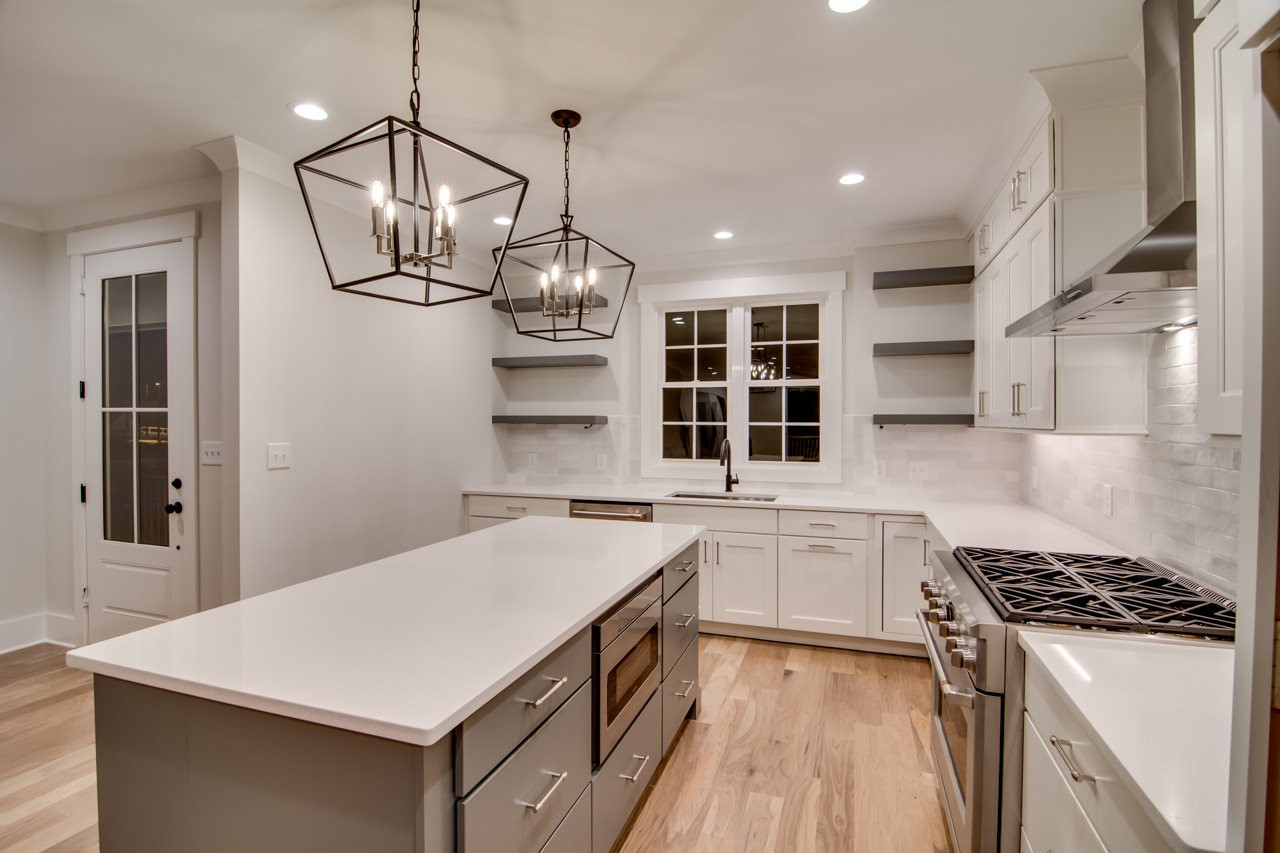 1006 Onslow Street Durham, NC 27705 - Photo 11 of 30 a kitchen with stainless steel appliances a sink a stove a refrigerator and cabinets