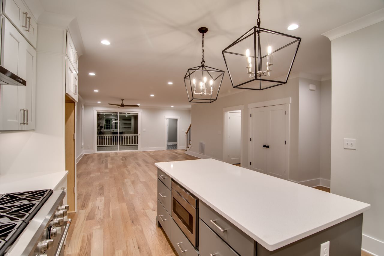 1006 Onslow Street Durham, NC 27705 - Photo 12 of 30 a large white kitchen with a large island oven a stove and white cabinets