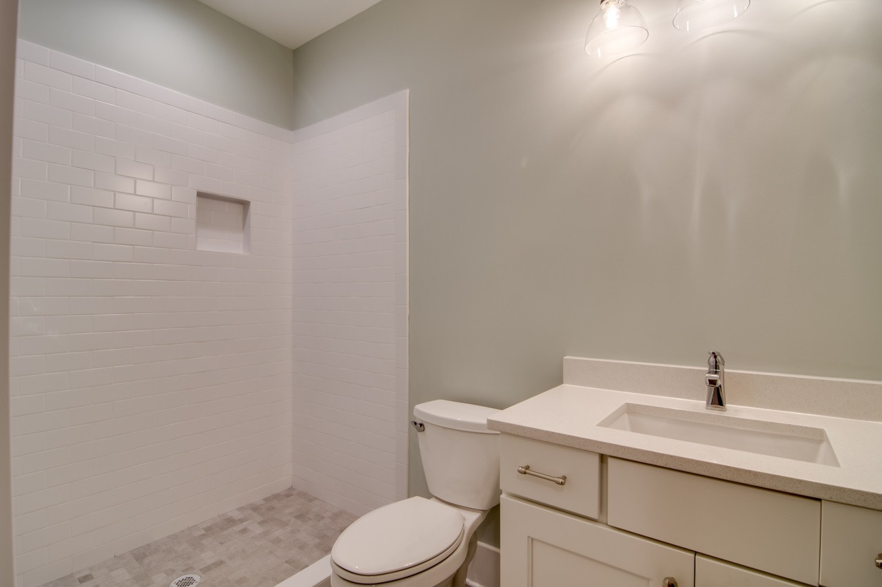1006 Onslow Street Durham, NC 27705 - Photo 22 of 30 a bathroom with a sink a toilet and a mirror