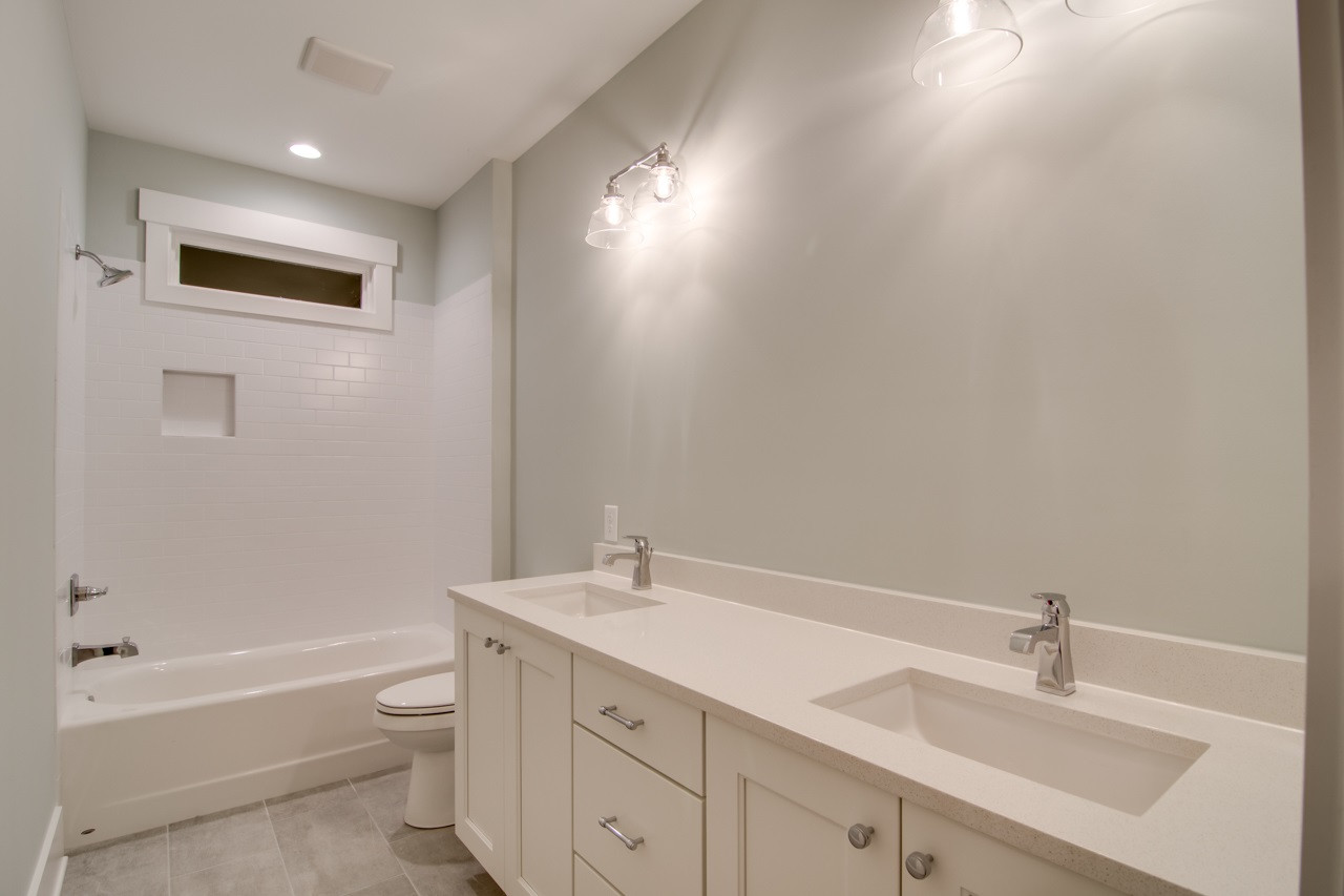 1006 Onslow Street Durham, NC 27705 - Photo 24 of 30 a bathroom with a sink a toilet and shower