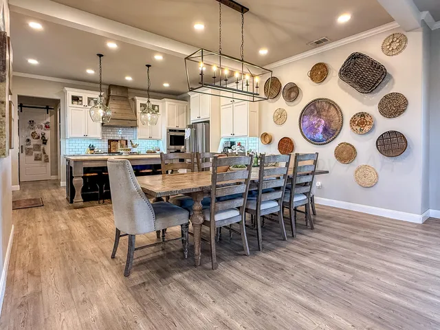 a large kitchen with a table and chairs