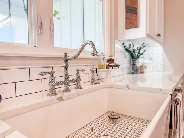 a bathroom with a sink and a window