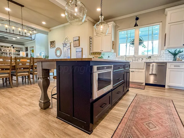 a kitchen with stainless steel appliances granite countertop a stove and cabinets
