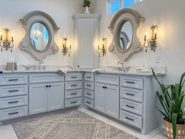 a bathroom with a granite countertop double vanity sink and a mirror