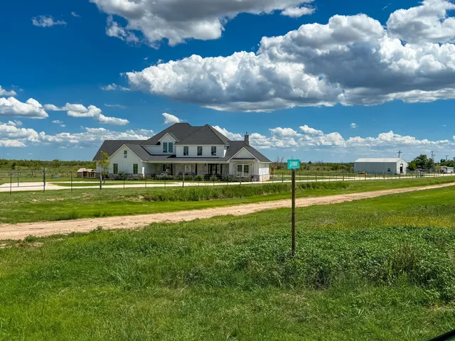 a view of a big house with a big yard