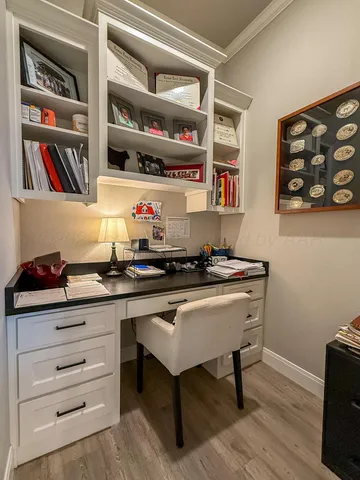 a room with a desk and book shelf