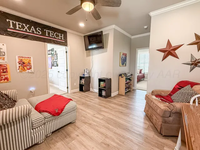 a bedroom with furniture and wooden floor
