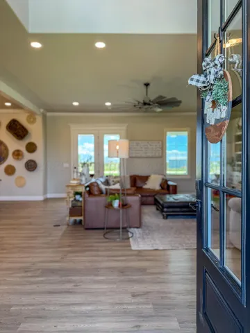 a living room with furniture and a chandelier