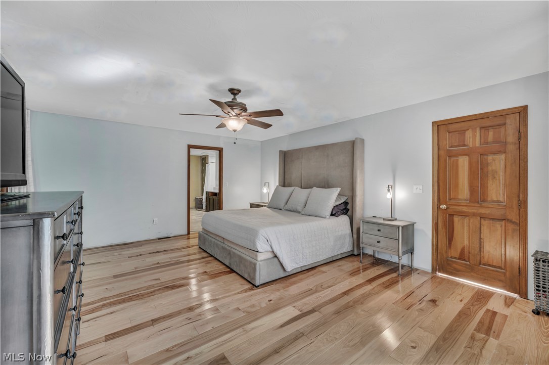6730 Avon Belden Road North Ridgeville, OH 44039 - Photo 25 of 35 1st floor Bedroom with ceiling fan and light hardwood flooring
