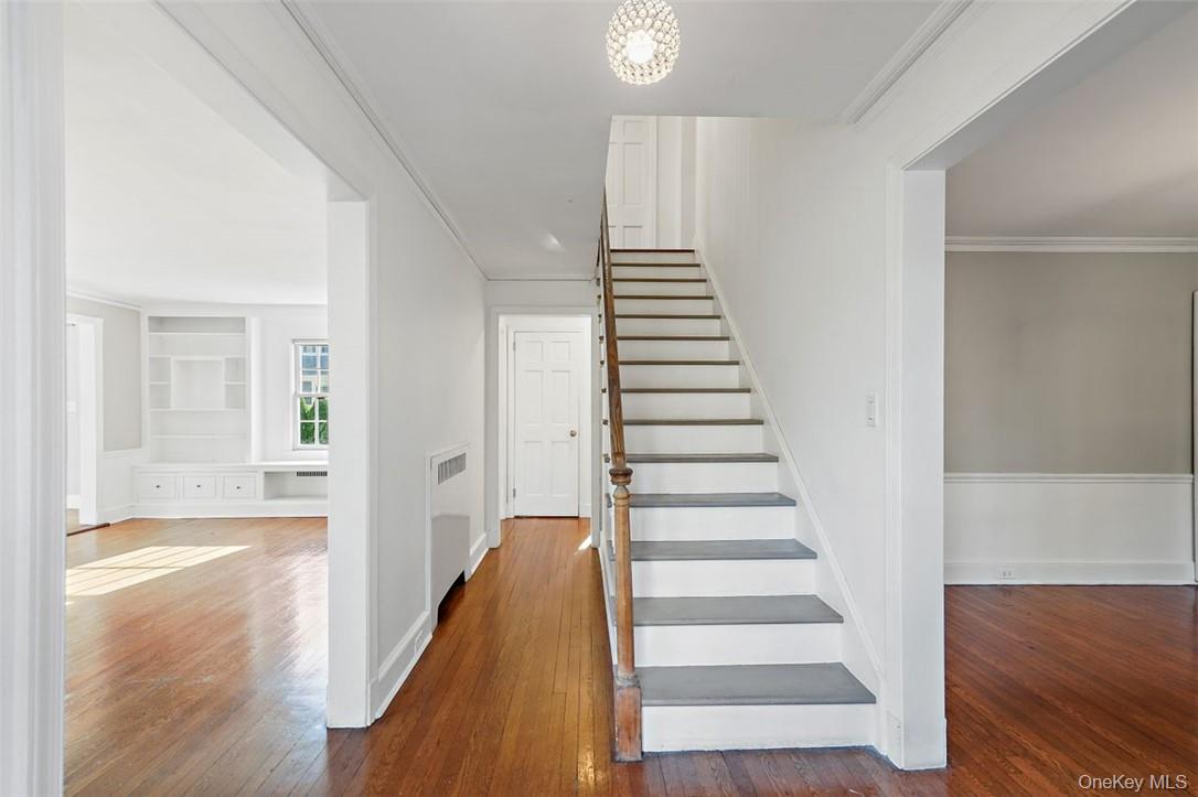 246 Mamaroneck Road Scarsdale, NY 10583 - Photo 2 of 35 First floor hallway showing a coat closet in back and powder room around the corner