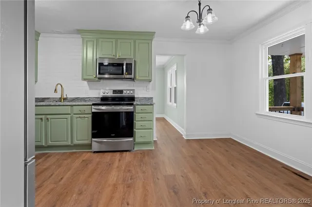 a kitchen with stainless steel appliances granite countertop a stove and a sink