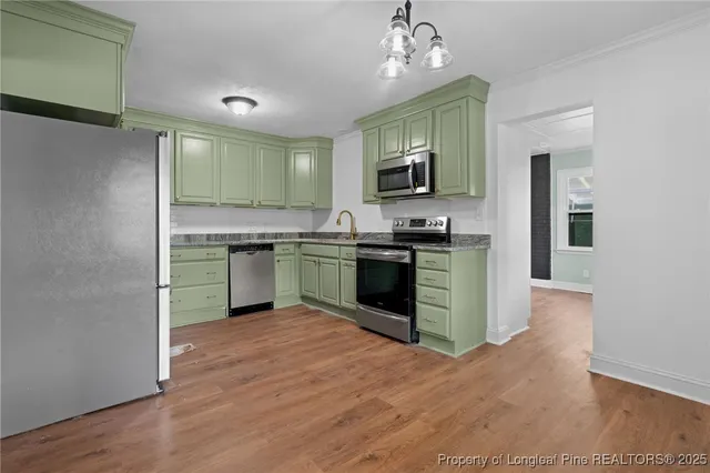 a kitchen with stainless steel appliances granite countertop a sink and stove top oven