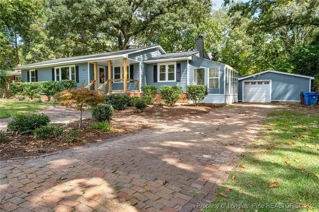 a front view of a house with a garden