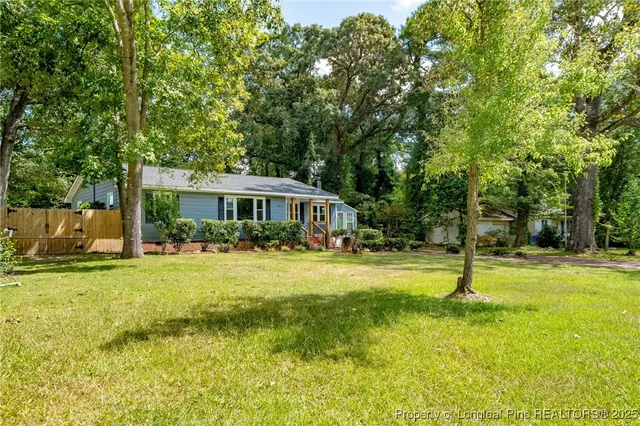 a front view of house with yard and green space