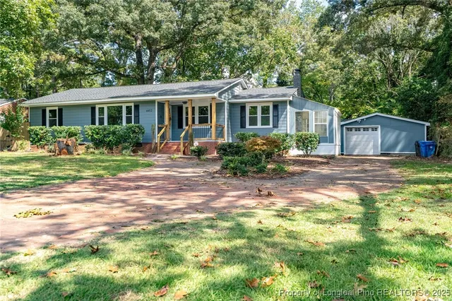 a front view of house with yard and green space