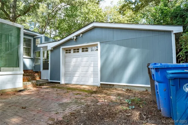 a view of backyard of house with green space