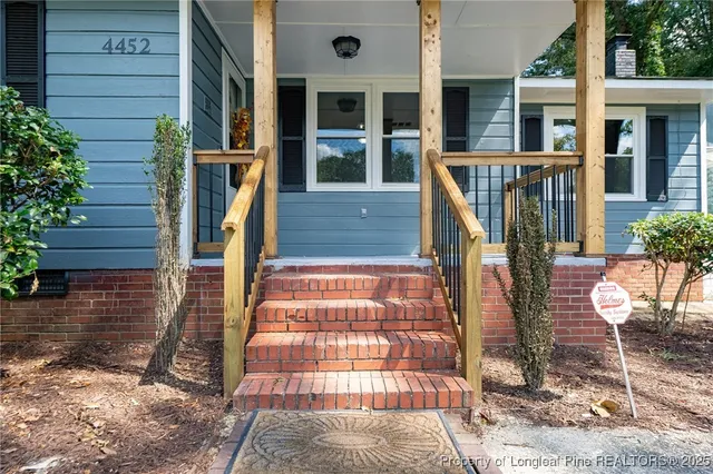a front view of house with a garden
