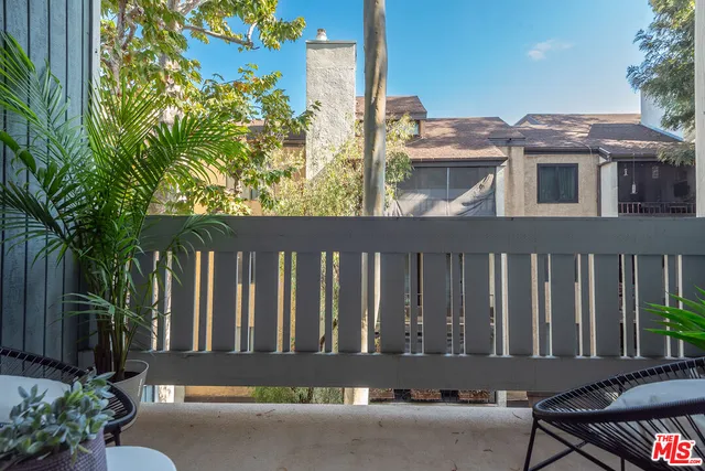 a view of a house with a small yard and wooden floor