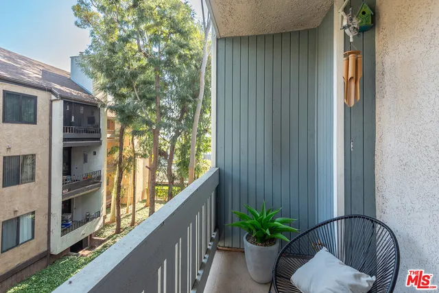 a view of balcony and small yard