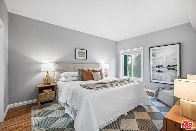 a bedroom with a bed and a lamp next to a window