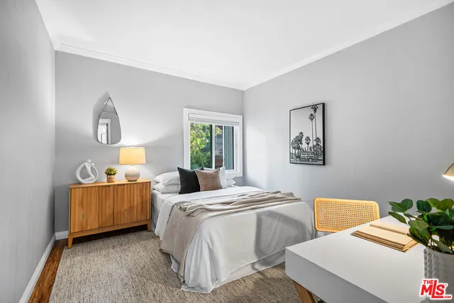 a bedroom with two beds and a couch