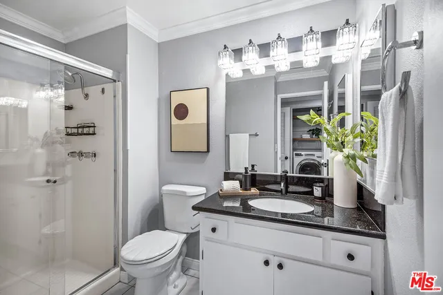 a bathroom with a granite countertop shower sink and mirror