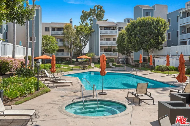 a swimming pool with outdoor seating and yard