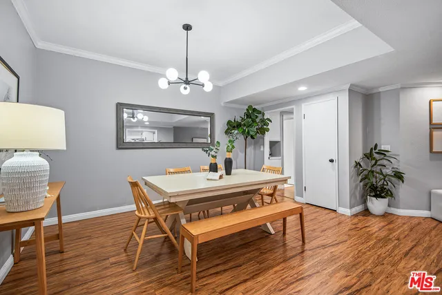 a view of a dining room with furniture wooden floor and chandelier