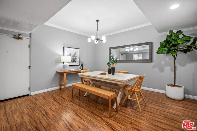 a view of a room with furniture and wooden floor
