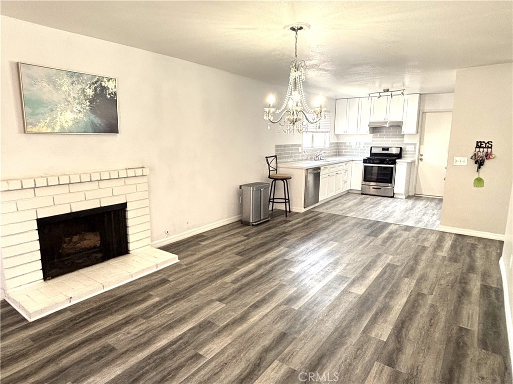 6845 Butte Drive Riverside, CA 92505 - Photo 11 of 27 a view of a kitchen with furniture and a fireplace