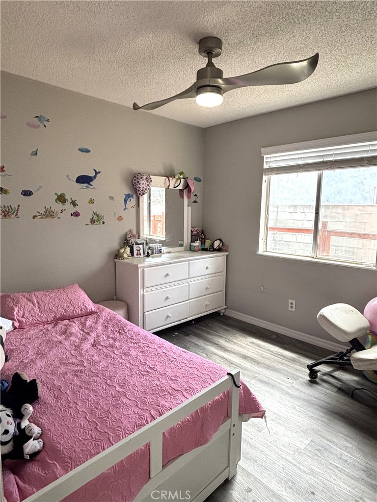 6845 Butte Drive Riverside, CA 92505 - Photo 14 of 27 a bedroom with a bed and a dresser