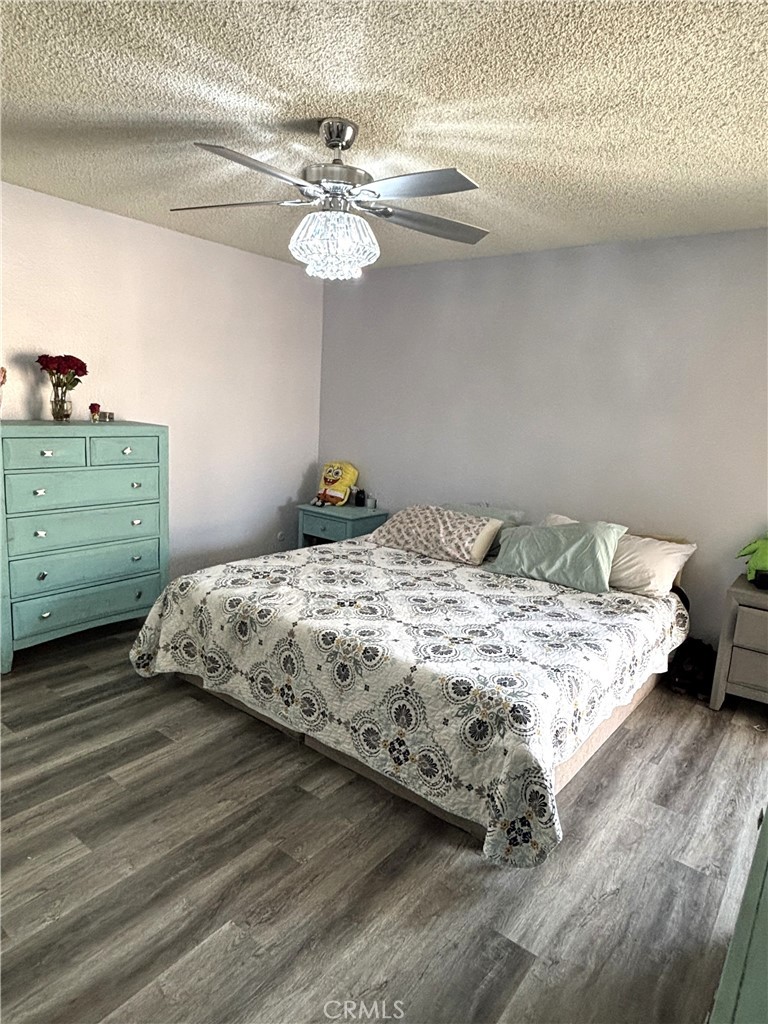 6845 Butte Drive Riverside, CA 92505 - Photo 19 of 27 a bedroom with a bed and cabinet