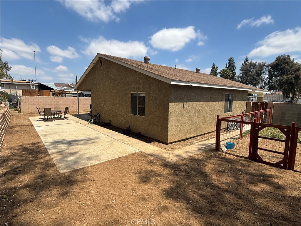 6845 Butte Drive Riverside, CA 92505 - Photo 22 of 27 a backyard of a house with large trees and garage