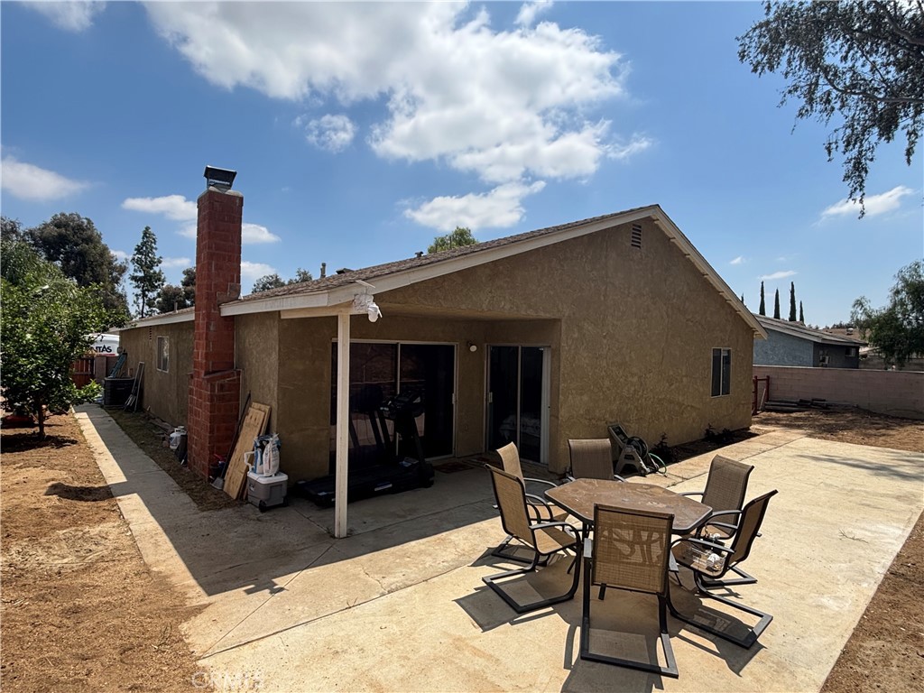 6845 Butte Drive Riverside, CA 92505 - Photo 24 of 27 a patio with table and chairs and potted plants