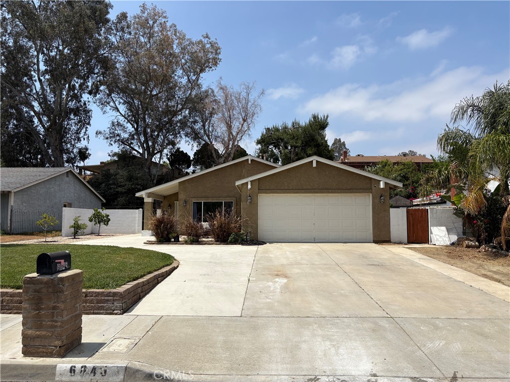 6845 Butte Drive Riverside, CA 92505 - Photo 26 of 27 a front view of a house with a yard and trees