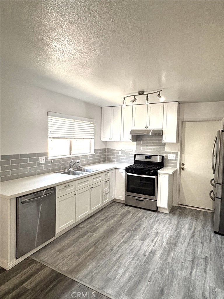 6845 Butte Drive Riverside, CA 92505 - Photo 8 of 27 a kitchen with a stove a sink and a window