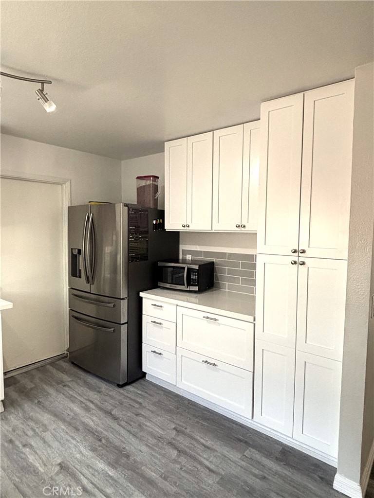 6845 Butte Drive Riverside, CA 92505 - Photo 9 of 27 a kitchen with a refrigerator sink and cabinets