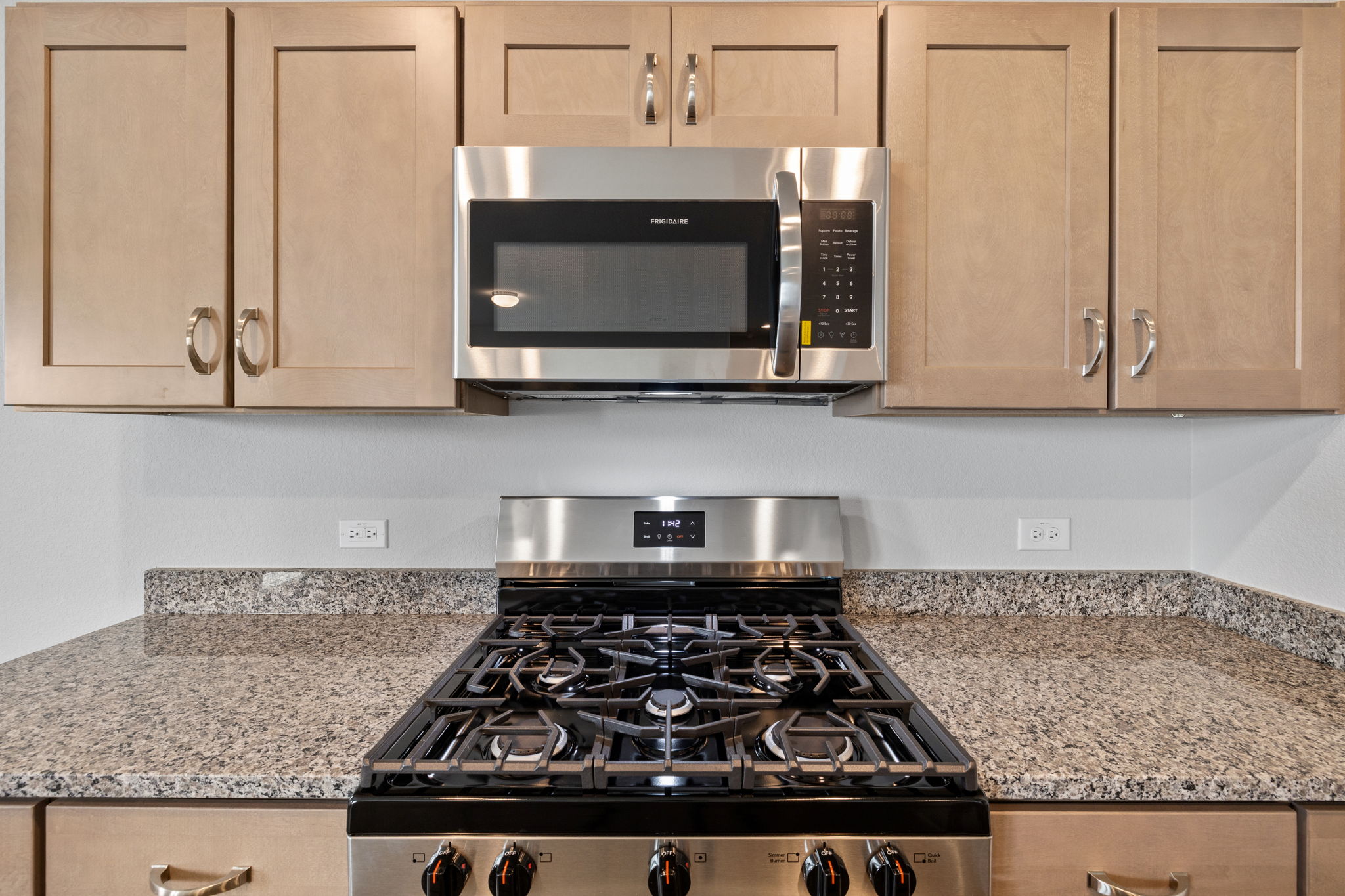 2460 Winding Creek Road Kyle, TX 78640 - Photo 5 of 20 A contemporary kitchen features robust stainless steel appliances, providing a functional and aesthetic cooking area.