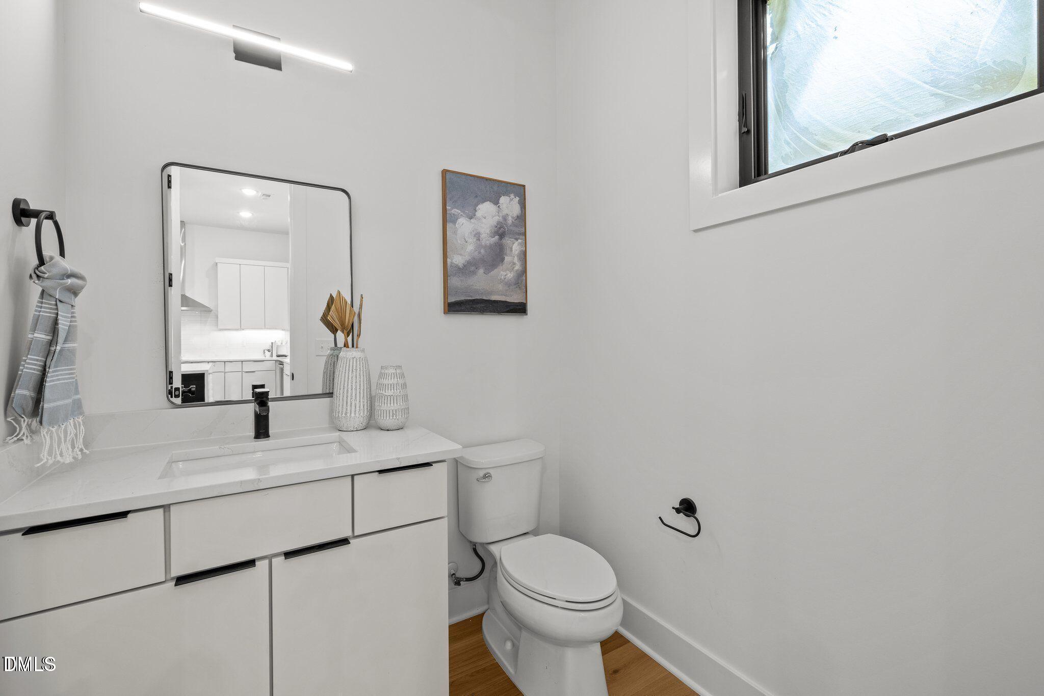516 Edgecreek Court Raleigh, NC 27604 - Photo 16 of 26 a bathroom with a toilet sink and mirror