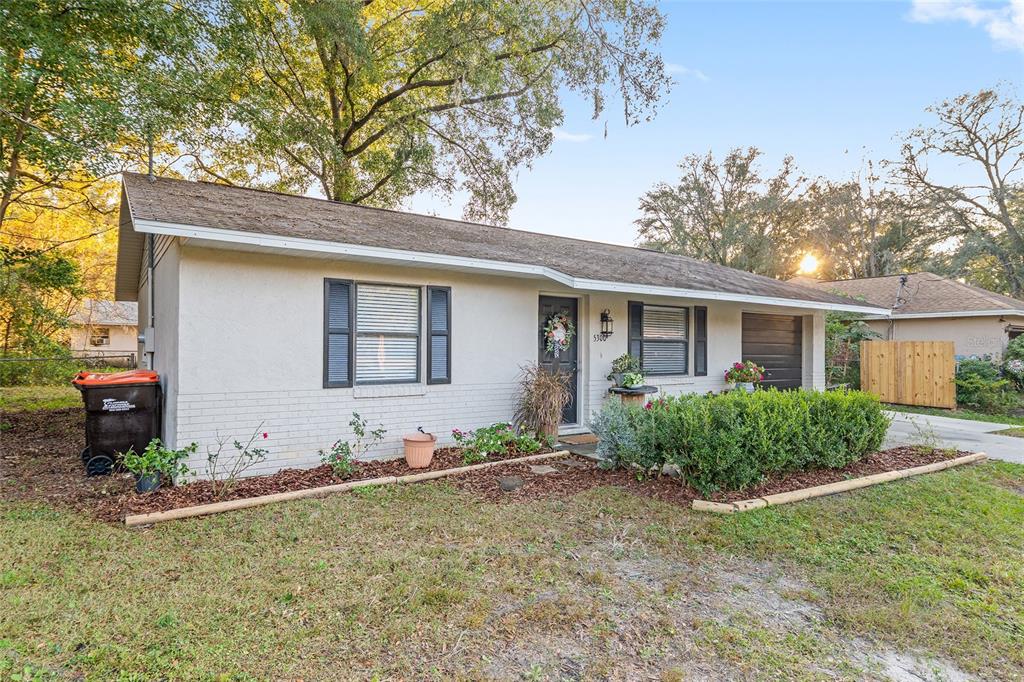5300 Southeast 102nd Place Belleview, FL 34420 - Photo 35 of 41 a front view of a house with garden