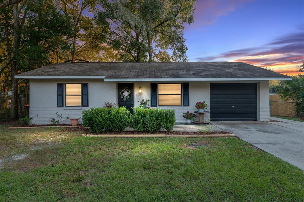 5300 Southeast 102nd Place Belleview, FL 34420 - Photo 36 of 41 a front view of a house with a yard and garage