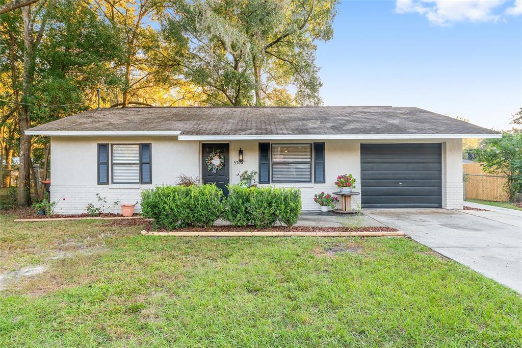 5300 Southeast 102nd Place Belleview, FL 34420 - Photo 37 of 41 a front view of a house with a yard